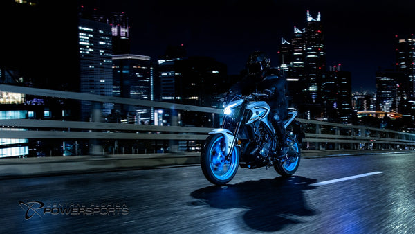 Side view of a rider on a 2026 Yamaha MT-03 in the city at night