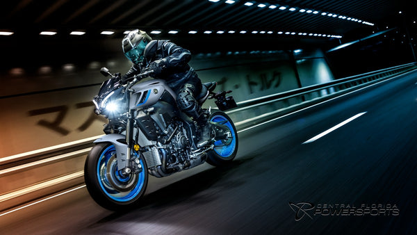 Rider on a 2026 Yamaha MT-10 crossing an illuminated city roadway