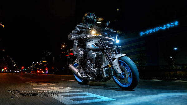 Rider approaching on a 2026 Yamaha MT-10 in the city at night