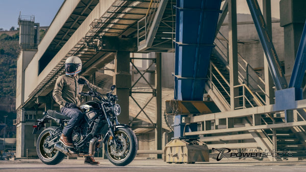 Rider stopped on a 2026 Yamaha XSR700 in an industrial setting