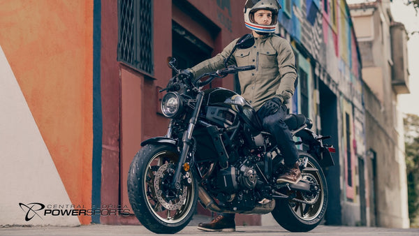 Rider stopped on a 2026 Yamaha XSR700 beside a painted city wall