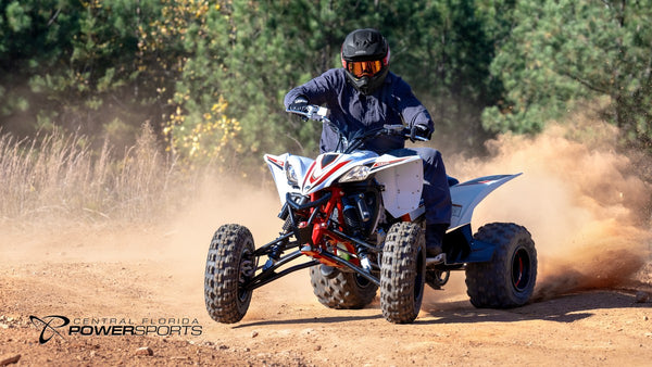 Helmeted rider cornering a 2026 Yamaha YFZ450R SE on a dirt trail