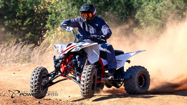 Helmeted rider steering a 2026 Yamaha YFZ450R SE through a dusty turn