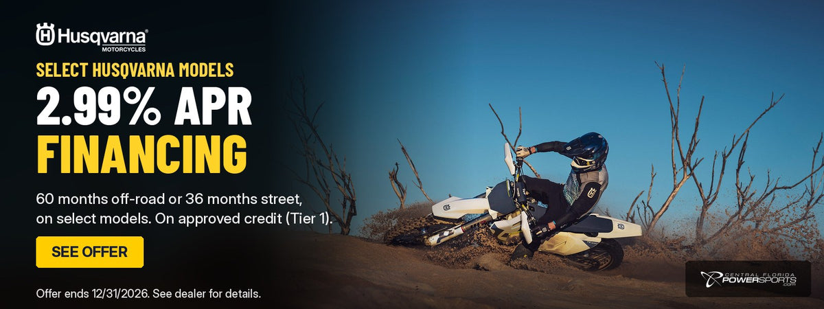 Husqvarna FX 350 rider carving a sand berm: 2.99% APR financing on select Husqvarna models. Offer ends 12/31/2026.